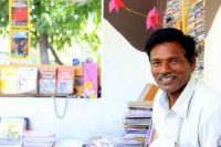 Illiterate man helping students with books