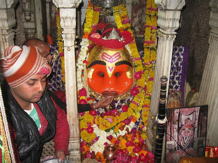 Devotees offer liquor to this deity